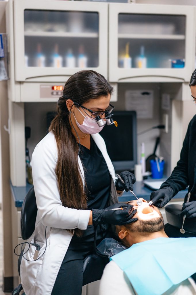 Glisten Dental hygienist using magnification loupes during a procedure